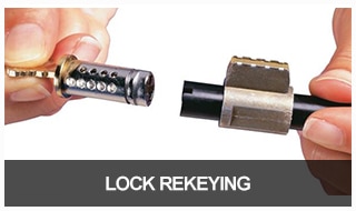 Image of a lock cylinder removed from a lock ready to be rekeyed.